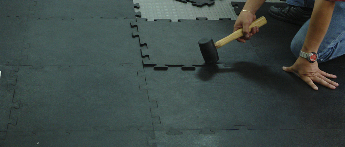 Professional installation of interlocking rubber puzzle flooring