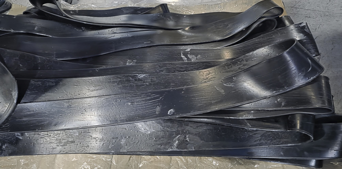 Blue and black uncured rubber rolls ready for elastomer contract manufacturing